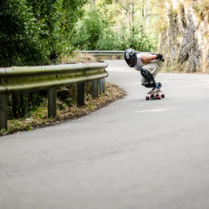 Downhill longboarder at full speed
