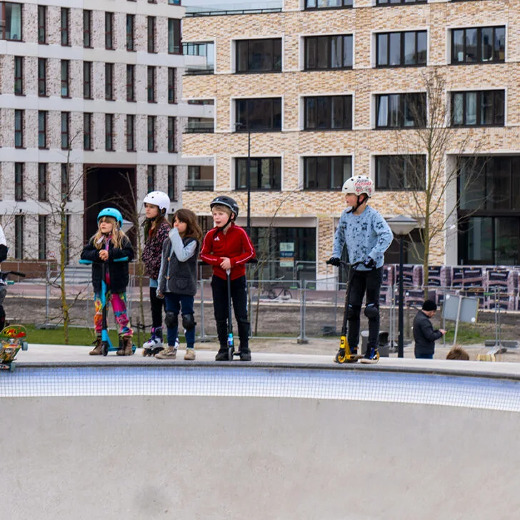 older skateboarder and kids in a skate park
